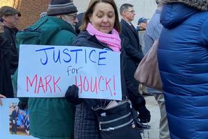 A woman attends a rally for Mark Houck outside the James A. Byrne U.S. Courthouse in Philadelphia on Jan. 24, while holding a sign that says, ‘Justice for Mark Houck!’