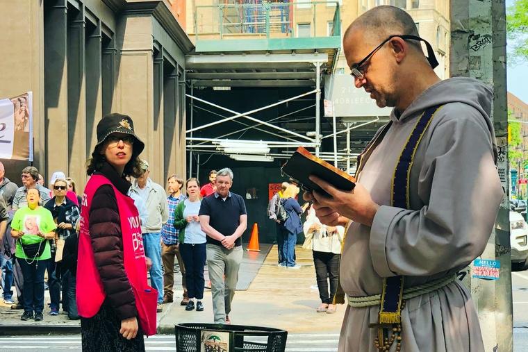 Father Fidelis Moscinski (r) prays at a pro-life gathering