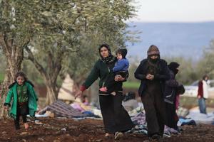 Syrians, displaced as a result of the deadly earthquake that hit Turkey and Syria two days ago, take shelter on the outskirts of the rebel-held town of Jindayris on February 8, 2023. 