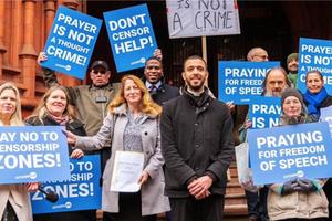 Isabel Vaughan-Spruce (center-left) and Father Sean Gough (center-right) celebrate their legal win outside the Birmingham Magistrates Court in Birmingham, England, on Feb. 16, 2023.