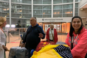 The Chakvetadze family arrives in Seattle, greeted by the Welcome Circle at Holy Family parish in Kirkland, Washington, which is sponsoring the family.