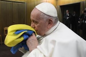 Pope Francis kisses a Ukrainian flag as he attends a Vatican screening of the 2022 documentary ‘Freedom on Fire: Ukraine’s Fight for Freedom’ on Feb. 24.