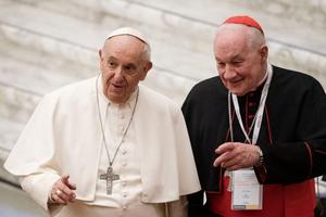Pope Francis arrives with Cardinal Marc Ouellet (R) of Canada for opening of 3-day Symposium on priesthood in the Paul VI hall at the Vatican on February 17, 2022.
