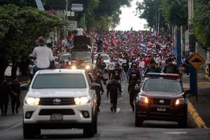 Supporters of Nicaraguan President Daniel Ortega take part in a pro-government march in Managua on February 11, 2023.  Nicaragua released and expelled to the United States 222 detained members of Nicaragua's opposition, stripping them of their citizenship, in a surprise move by the Central American country's increasingly authoritarian president, Daniel Ortega.
