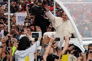 Pope Francis waves as he arrives at the University of Santo Tomas during his visit to Manila on Jan. 18, 2015. Pope Francis celebrated Mass with millions of Catholics. 