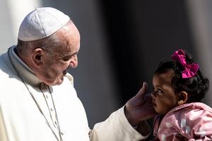 Pope Francis greets a young child at his general audience on April 17, 2019.