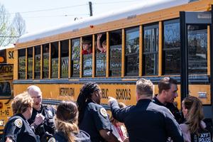 School buses with children arrive at Woodmont Baptist Church to be reunited with their families after a mass shooting at Covenant School on March 27 in Nashville, Tennessee. 