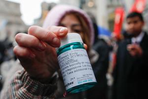A pro-abortion activist displays abortion pills as she counter-protests during an pro-life demonstration on March 25, 2023 in New York City. 