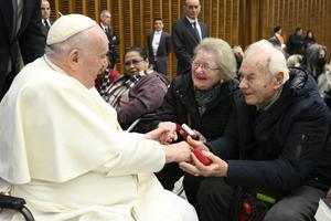 Pope Francis greets an elderly couple at his general audience on Jan. 11, 2023