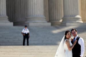 A couple poses for wedding pictures in front of the U.S. Supreme Court Building in Washington, DC, on April 21, shortly before the Supreme Court blocked a lower court’s order that would have stopped the distribution of the abortion drug mifepristone nationwide.