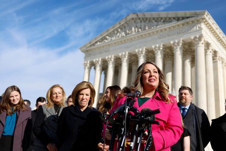 Lorie Smith, the owner of 303 Creative, a website design company in Colorado, speaks to reporters outside of the U.S. Supreme Court Building on Dec. 5.  