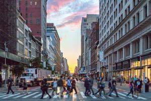 Crowds of people crossing an intersection in Manhattan.