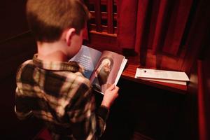 Young boy reads from Renewed book series by Ascension Press.