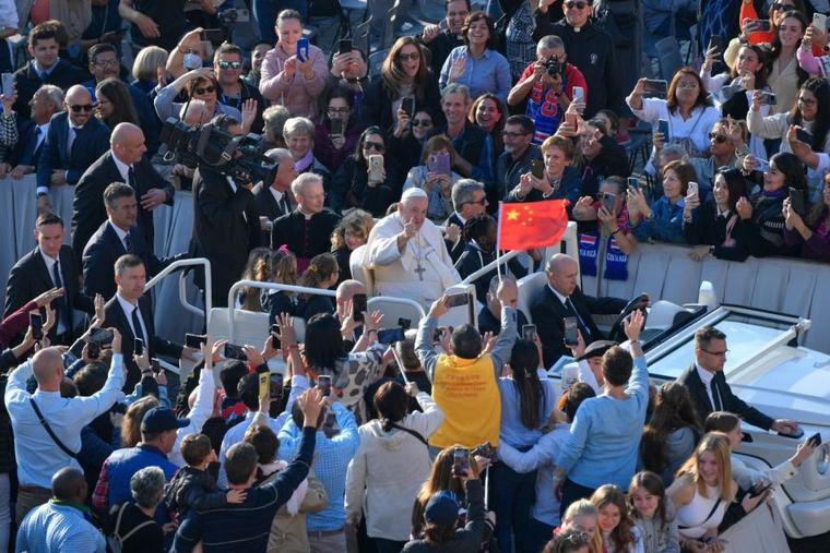 Pilgrims wave a Chinese flag at the general audience with Pope Francis, Oct. 12, 2022.