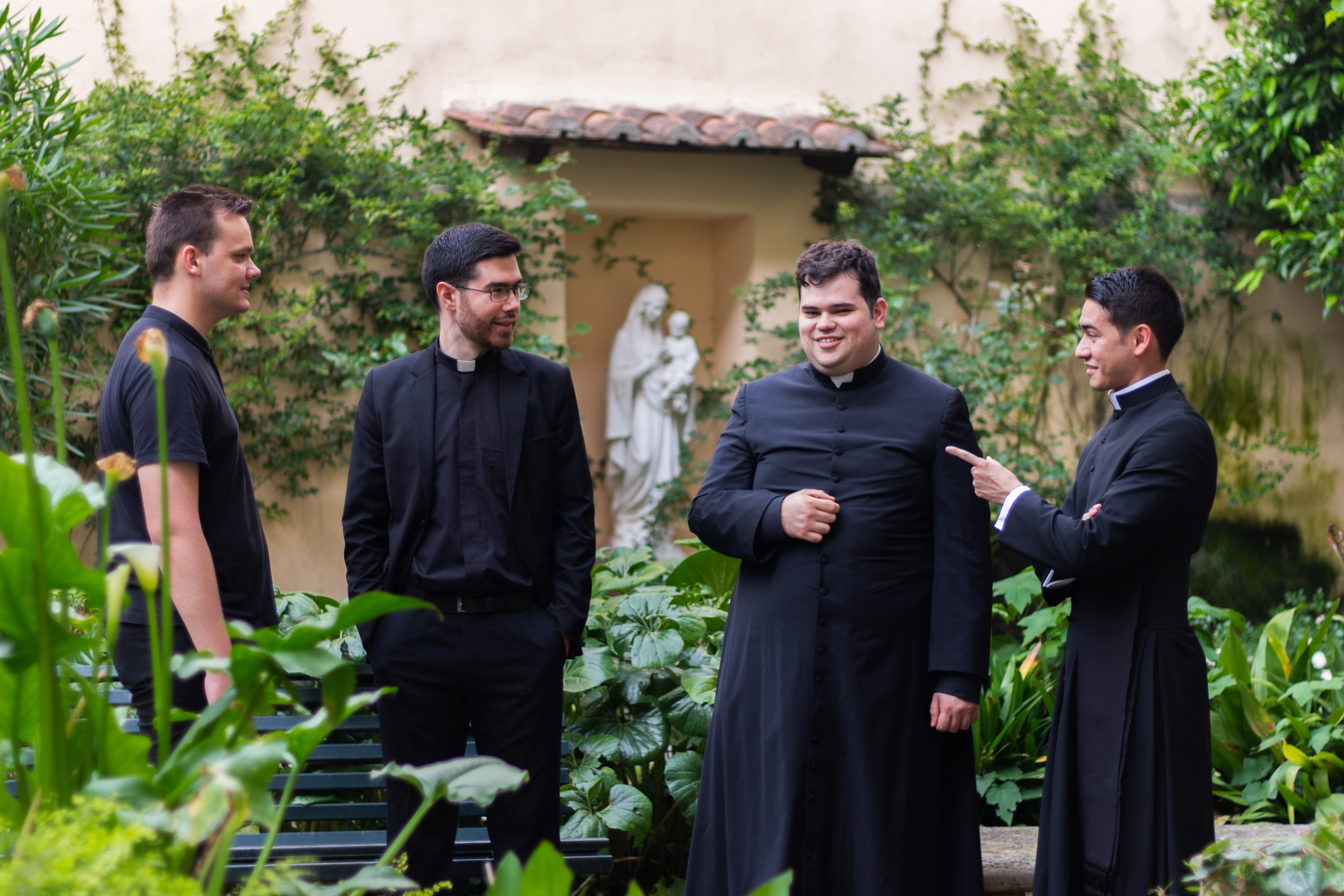 Four seminarians share time together in Mary's garden. 