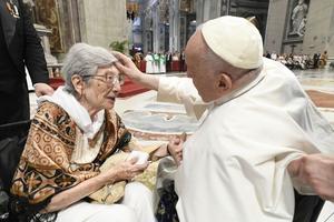 Pope Francis blesses a woman in St. Peter's Basilica, where he presided over a special papal Mass on July 23, 2023, marking the third annual World Day for Grandparents and the Elderly.