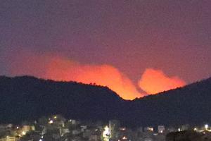 Drevenochoria Fire as seen from Ilion, Attika, at approximately 2am on July 18. Flames are not shown;  the glare from the fire looks like flames due to the settings of the camera.