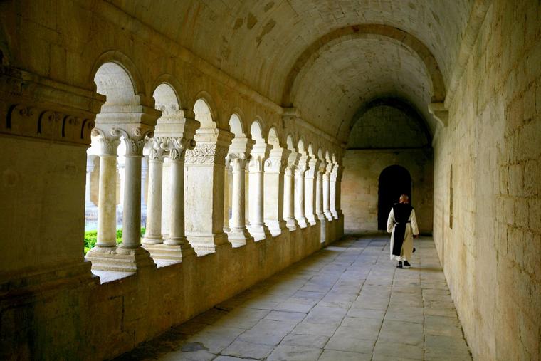 A Cistercian monk walks in Sénanque Abbey in Provence, France.