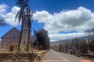 Burned houses are seen adjacent of Maria Lanakila Catholic Church, on Waine street, in the aftermath of a wildfire in Lahaina, western Maui, Hawaii on August 11, 2023.  