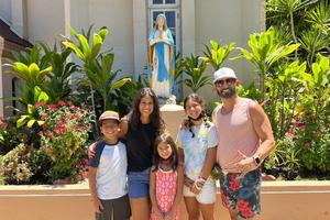 The Cardenas family, of Sacramento, California, poses outside Maria Lanakila Catholic Church in Lahaina, Hawaii.
