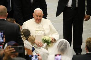 Pope Francis greets newly married couples at the general audience in the Vatican's Paul VI Hall on Aug. 30, 2023.