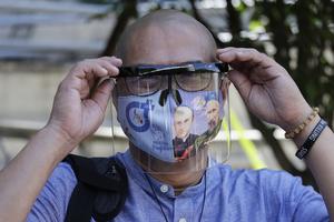 Catholic priest Father Flaviano "Flavie" Villanueva adjusts his face shield as he arrives at a trial court in Manila, Philippines, Thursday Feb. 11, 2021. Three priests including Villanueva, who are critical of the president's bloody crackdown against illegal drugs, appeared in court to face charges on alleged conspiracy to commit sedition. 