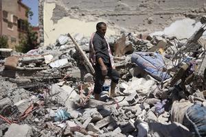 People search in destroyed houses and buildings in the city of Amizmiz, southwest of Marrakesh, on September 11, 2023. Moroccans mourned the victims of a devastating earthquake that killed more than 2,000 people as the first foreign rescuers flew to help search the rubble of flattened villages. 