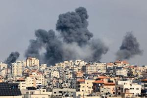 Smoke rises over Gaza City on Oct. 7, during Israeli airstrike. Palestinian militants have begun a ‘war’ against Israel, the country’s defense minister said on Oct. 7, after a barrage of rockets were fired and fighters from the Palestinian enclave infiltrated Israel, a major escalation in the Israeli-Palestinian conflict. 