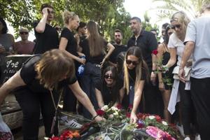 Family and friends of May Naim, 24, who was murdered by Palestinians militants at the Supernova festival near the Israeli border with Gaza Strip, react during her funeral on Oct. 11 in Gan Haim, Israel. 