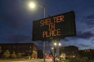 A sign advises residents to stay home, Thursday, Oct. 26, 2023, following a mass shooting at a restaurant and a bowling alley in Lewiston, Maine. Police continue to search for the suspect. 