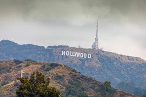 The Hollywood sign is seen, along with a cross, in the hills above Los Angeles.
