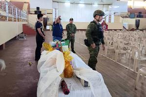 Governor Mamintal Bombit Alonto Adiong, Jr. second from left, talks with law enforcers at the site of an explosion in Marawi city, southern Philippines on Sunday Dec. 3, 2023. A powerful explosion believed caused by a bomb ripped through a Catholic Mass and killed several people and wounded dozens of others Sunday in a predominantly Muslim city in the southern Philippines, officials said. 