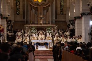 The Latin patriarch of Jerusalem, Cardinal Pierbattista Pizzaballa, presides over the Christmas midnight Mass in the Church of St. Catherine in Bethlehem. With him, Cardinal Konrad Krajewski, papal envoy, H. E. Adolfo Tito Yllana, apostolic delegate in Jerusalem and Palestine, and the bishops of the Latin Patriarchate of Jerusalem concelebrated, Dec. 25.
