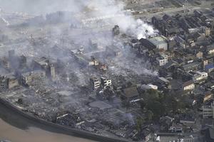 Smoke rises from the site of a fire occurred following an earthquake in Wajima, Ishikawa prefecture, Japan Tuesday, Jan. 2, 2024. 