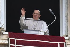 Pope Francis waves during the Angelus on Jan. 7; he offered pilgrims gathered in St. Peter's Square a reflection on baptism.