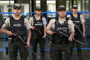Police officers stand guard outside the City Hall building in Quito on Jan. 10, as Ecuador remains in a state of emergency following the escape from prison of a dangerous narco boss. 