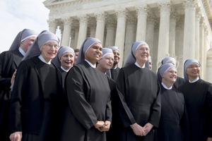 A group of the Little Sisters of the Poor stands in front of the Supreme Court Building in Washington, DC, March 23, 2016.