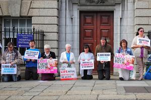 Members of the group ‘Our Lady of Lourdes Protectors’ hold a prayer vigil outside the national maternity hospital in Dublin, Ireland.