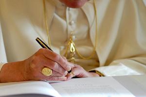 Pope Benedict XVI signs “Spe Salvi,” the second encyclical of his pontificate, Nov. 30, 2007, at the Vatican.