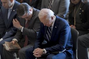 President Joe Biden, with from left, House Minority Leader Hakeem Jeffries, D-N.Y., and House Speaker Mike Johnson of La., pray and listen during the National Prayer Breakfast, Thursday, Feb. 1, 2024, at the Capitol in Washington. 