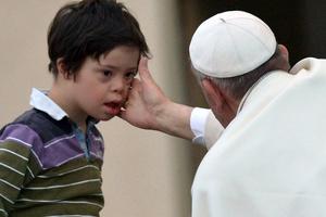 Pope Francis blesses a child with Down syndrome May 18, 2013, in St. Peter’s Square at the Vatican.