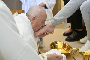 Pope Francis kisses the foot of one of the 12 women whose feet he washed at the Rebibbia Women’s Prison in Rome on Holy Thursday, March 28.