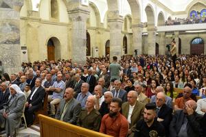 Iraqi Catholic Christians attend Easter Sunday Mass at Qaraqosh’s Al-Tahera (Immaculate Conception) Church in the Hamdaniyah district in the northern Iraqi province of Nineve, on April 17, 2022. The church, established during the seventh century east of Mosul, had been torched by the Islamic State (IS) group when it swept into the northern Iraqi province in 2014 and was later heavily damaged in fighting with jihadists, who were ousted from the town in 2016. The church’s imposing marble floors and columns were restored just before Pope Francis’ visit to Iraq in 2021.