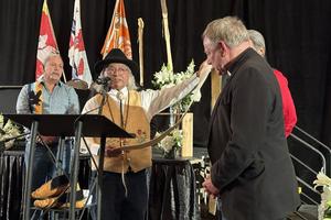 Vancouver Archbishop J. Michael Miller is presented with a gift at the Sacred Covenant signing on Sunday, March 31, 2024.