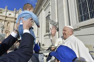 Pope Francis blesses a baby at his Wednesday general audience on March 20, 2024, in St. Peter’s Square at the Vatican.