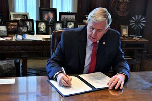 Missouri Gov. Mike Parson signs a bill in 2020.