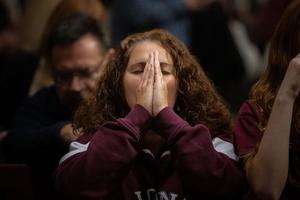 A Massgoer prays at St. Patrick’s Cathedral in New York City before a Eucharistic procession through the streets Oct. 10, 2023.