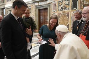 Pope Francis blesses an unborn baby during the Papal Foundation's annual pilgrimage in Rome on Friday, April 12, 2024.