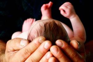 Father holds newborn.