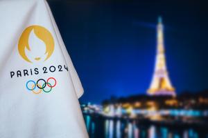 Paris Olympics 2024 logo next to the Eiffel Tower. 